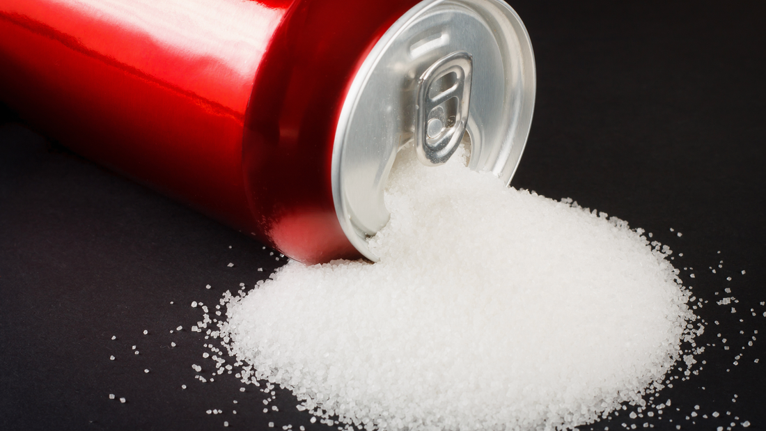 Energy drink can spill a pile of sugar, illustrating why an NAD+ drink is a better low‑sugar alternative to traditional energy drinks.